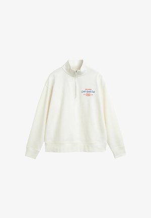Cream-colored pullover sweatshirt with a half-zip collar, featuring embroidered text: "NEW HAVEN Gant Sports Club 1949 USA." Soft texture.