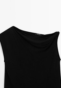 Black draped top with an asymmetric neckline, made from soft, textured fabric. Features a tag labeled "Massimo Dutti" near the neckline.