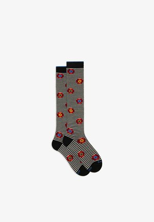 Knee-high socks featuring a black and white striped pattern with red, blue, and yellow floral designs and solid black accent at the top.