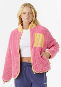 Uldet pink jakke med gule accenter, lynlåslomme på brystet og sidelommer, der har en afslappet pasform og ribbede manchetter.