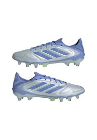 Luminous silver and lavender soccer cleats with green accents, featuring a streamlined design, textured surface, and molded studs for traction.