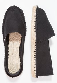 Black canvas espadrilles with jute soles, featuring a round toe and side openings. The seams are visible, highlighting the woven sole texture.
