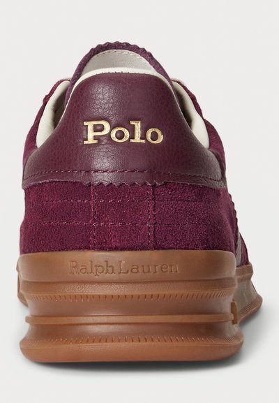 Maroon suede and leather sneaker heel with gold "Polo" logo and brown sole embossed with "Ralph Lauren" branding.