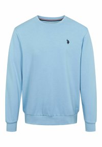 Vaaleansininen collegepaita, joka on valmistettu pehmeästä kankaasta. Siinä on pyöreä pääntie, pitkät hihat ja pieni musta logo rinnassa.