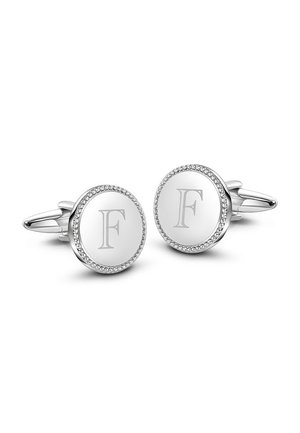 Srebrne spinki do mankietów w okrągłym kształcie, z centralnym grawerem "F" oraz perełkowym brzegiem. Gładka powierzchnia z polerowanym wykończeniem.