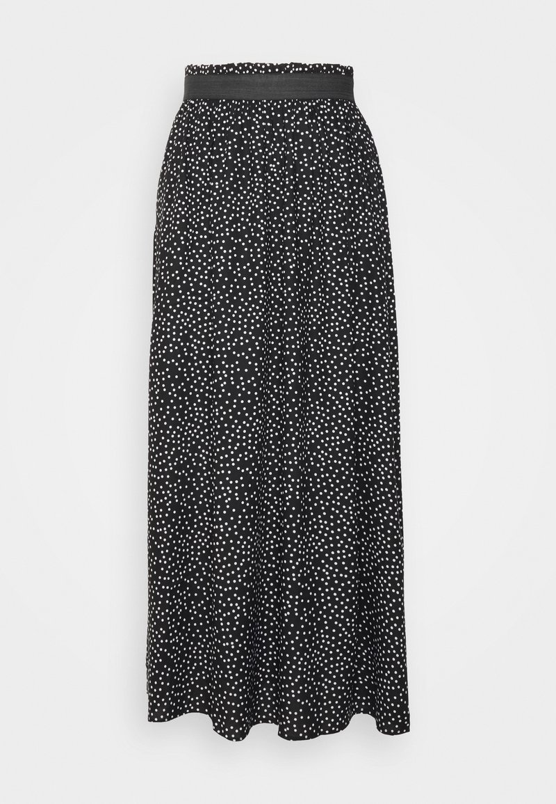 Jupe longue noire à pois blancs, avec une large ceinture élastique et un tissu ample et fluide.