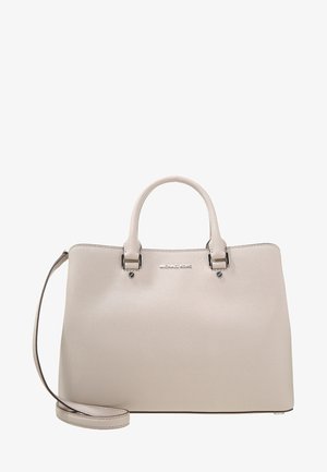 Sac à main beige Michael Kors avec doubles poignées supérieures, bandoulière amovible et détail logo argenté sur surface en cuir lisse.
