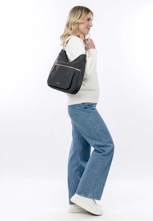 Black leather shoulder bag with gold accents, a front zipper pocket, and a soft, curved design. Worn on the shoulder with a silver strap.