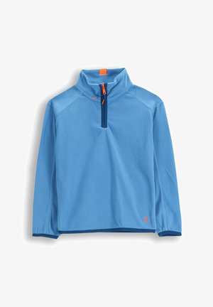 Jasnoniebieski polarowy sweter z ćwierć zamkiem w ciemnoniebieskim kolorze oraz pomarańczowym uchwytem, z kołnierzem stojącym i małym pomarańczowym logo przy dolnym brzegu.