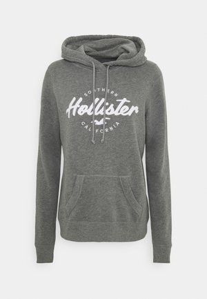 Grå hettegenser laget av blandingsbomull, med en frontlomme, snor og en hvit sirkel-logo med "Hollister Southern California."