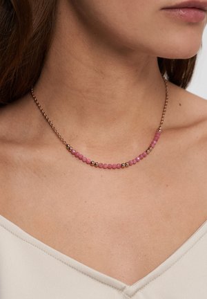 Pink gemstone necklace featuring small round stones alternated with gold-tone metal beads, set on a delicate chain.