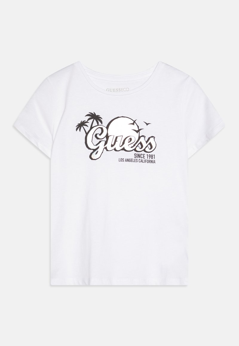 Vit t-shirt med kort ärm som har ett svart grafiskt tryck av en sol, palmer och texten "Guess" samt "Sedan 1981 Los Angeles Kalifornien."