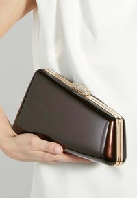 Brown glossy clutch with gold-tone clasp, rectangular shape, smooth texture, featuring crystal accents on the clasp.