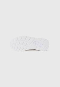 White sneaker sole with textured rubber, featuring a hexagonal pattern and a small translucent window near the heel.