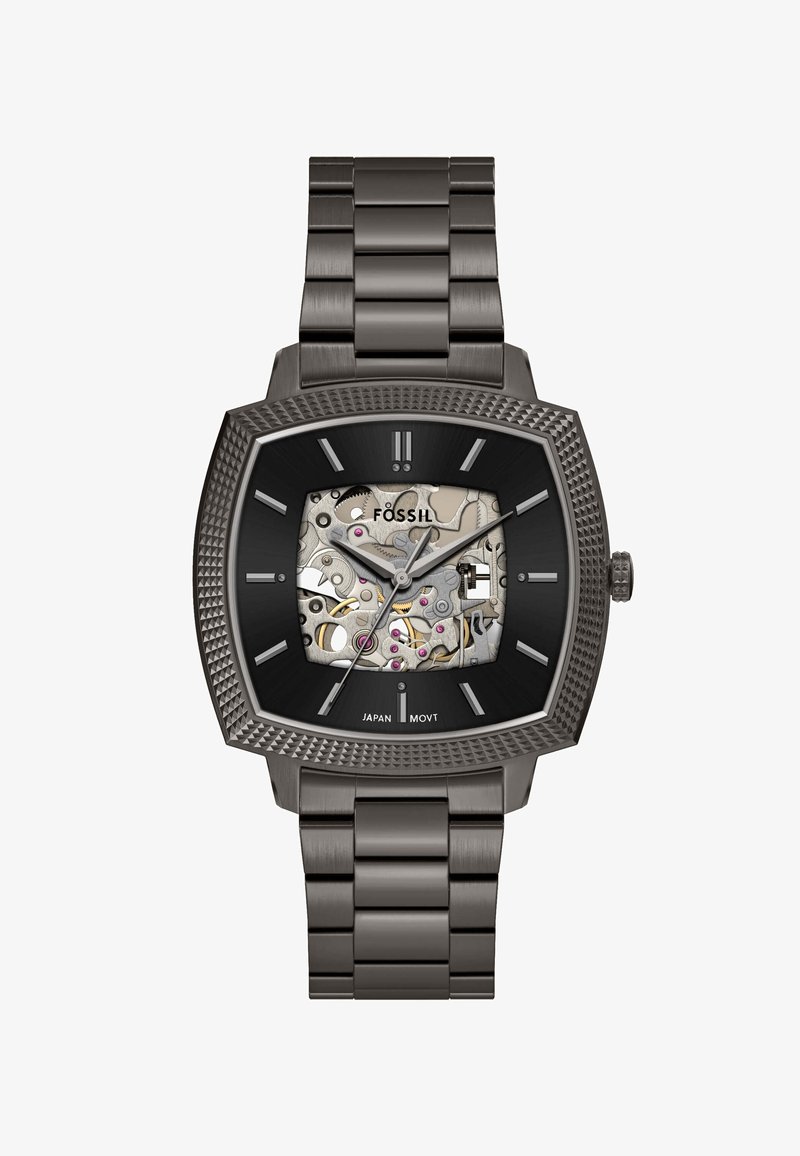 Quadratische mechanische Uhr mit einem Armband aus Edelstahl, schwarzem Zifferblatt und transparentem Gehäuse, das komplexe Mechanismen und rosa Akzente zeigt.