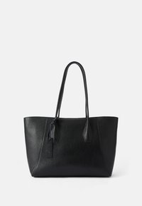 Black leather tote bag with a textured surface, elongated shape, two sturdy handles, and a small decorative tag on the side.