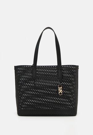 Czarna pleciona torba typu tote z dwoma paskami na ramię i małym złotym zawieszonym u boku wisiorkiem z logo MKO.