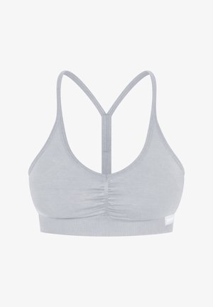 Sport bra grigio chiaro con materiale morbido e elasticizzato, spalline incrociate e centro arricciato con una banda texturizzata.