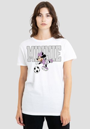 Young woman wearing white T-shirt featuring Minnie Mouse in purple outfit kicking a soccer ball, with "MINNIE" text above.