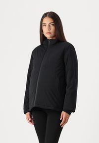Black insulated jacket with a stand collar, front zipper, side pockets, and a relaxed fit. Smooth texture, lightweight design.