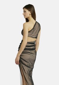 Schwarzes, durchsichtiges Kleid mit Design über einer Schulter, drapiertem Stoff, geraffter Textur und einem hohen Schlitz bis zum Oberschenkel. Freie Rückenpartie mit kontrastierendem Band.