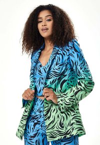 Multicolored suit set featuring a blazer and fitted top in blue and green with black tiger stripes. Fabric has a smooth, glossy finish.