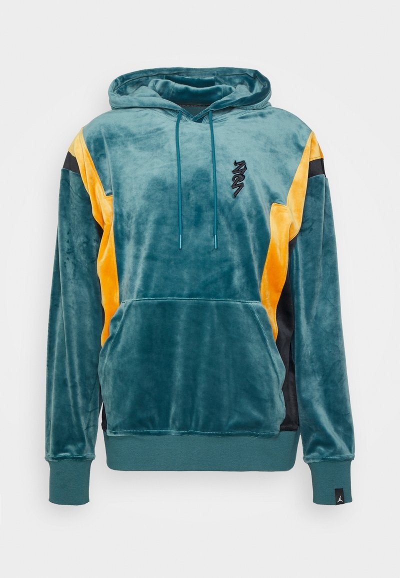 Sweat à capuche en velours doux bleu sarcelle et jaune avec poche avant, cordons de serrage, logo noir sur la poitrine et poignets et ourlet côtelés.
