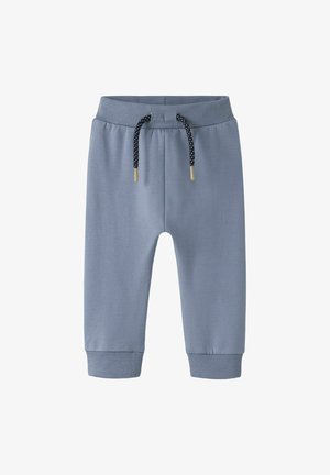Light blue jogger pants made of soft fabric, featuring a ribbed waistband, black polka-dot drawstring, and ribbed cuffs.