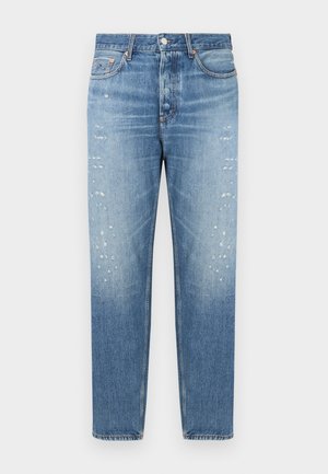 Light blue denim jeans with a straight cut, featuring distressed patches on the front and a button-fly closure. Classic five-pocket design.