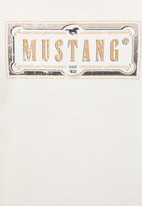 Mustang logo with a running horse above stylized text "MUSTANG" and "Since 1932" inside a rectangular vintage frame.