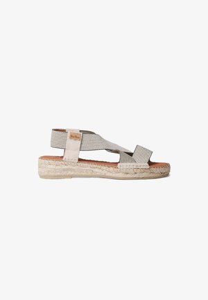 Sandale espadrille beige et grise avec des sangles en tissu entrecroisées, une semelle en jute tissée texturée et une semelle intérieure en cuir marron.