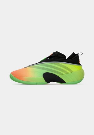 Sneaker with gradient colors from orange to green, black ankle collar, perforated stripes, and thick green sole, shown in side profile.