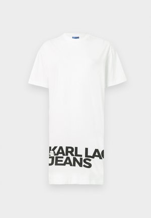 Balta trumpa rankovėmis marškinėliai, pagaminti iš medvilnės, su ryškiu juodu tekstu "KARL LAGERFELD JEANS" apačioje. Apvalus iškirpimas, laisvas siluetas.