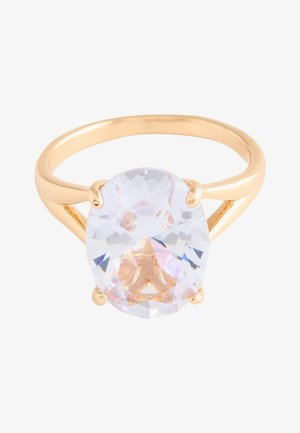 Gold ring with a large oval clear gemstone held by four prongs on a simple polished band.