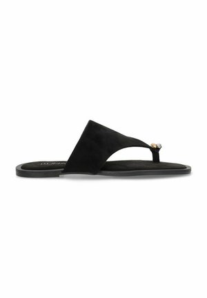 Sandalia de dedo de ante negro con suela plana, diseño minimalista y un acento metálico decorativo cerca de la tira del dedo.