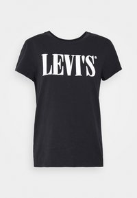 Černé bavlněné tričko s kulatým výstřihem a krátkými rukávy, s výrazně vytištěným logem "LEVI'S" v bílé barvě přes hruď.