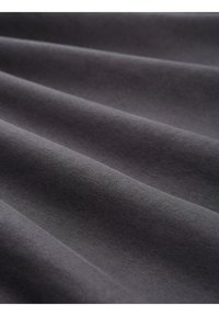 Țesătură de culoare gri-charcoal cu o textură netedă și moale, prezentând multiple pliuri și un model de țesere uniform și consistent.