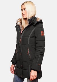 Black puffer jacket with a fur-lined hood, quilted texture, gray accents, zippered pockets, and logo patch on the sleeve.