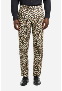 Leopardenmuster-Hosen in hellbeige mit schwarzen und orangefarbenen Flecken, mit einem elastischen Bund und schmalem, geradem Schnitt, kombiniert mit schwarzen Schuhen.