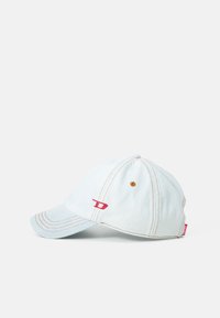 Light blue denim baseball cap with a curved brim, contrasting orange stitching, and a small red logo on the side.