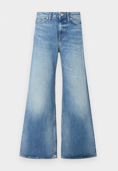 Light blue denim flared jeans with a high waist, five-pocket design, subtle fading, and stitched brand logo above the rear pocket.