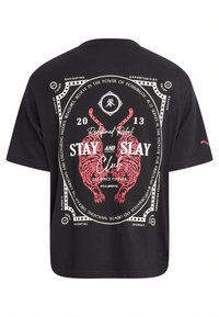 Camiseta de algodón negra con mangas cortas, que presenta un gráfico rojo de tigres, texto y elementos decorativos en la parte posterior.