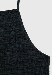 Dark textured fabric with a crinkled design. Features thin straps and an asymmetrical neckline. Suitable for casual wear.