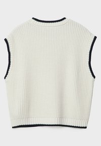Haut sans manches en maille couleur crème avec texture côtelée et bordure noire au niveau de l'encolure et des emmanchures. Coupe courte.