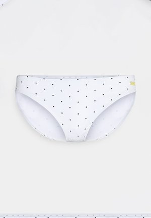 Hvid bikini bund med små sorte prikker, med en glat tekstur, elastisk talje og etmærke på siden.