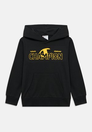 Felpa nera con cappuccio e tasca frontale, logo "Champion" giallo e testo "Authentic Athleticwear" sul petto.