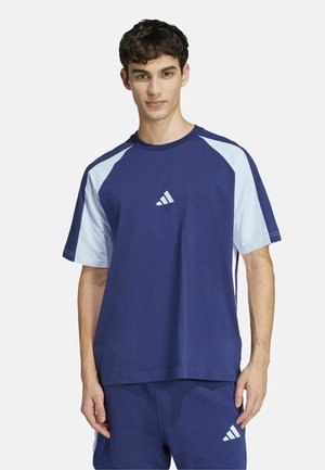 Navy blue cotton t-shirt with light blue raglan sleeves, round neck, featuring a small white adidas logo on the chest. Casual fit.