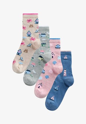Four colorful socks with seaside designs including crabs, beach chairs, houses, shells, sailboats, and a lighthouse.
