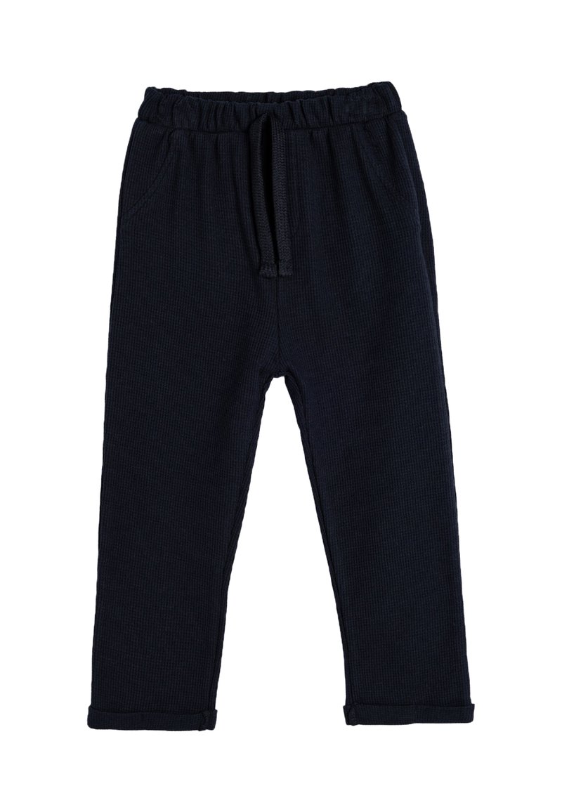 Pantalones de punto azul marino con cintura elástica y cordón. Cuenta con bolsillos laterales y dobladillos enrollados. Textura suave y diseño ajustado.