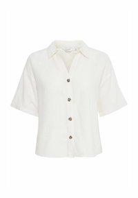 Blusa bianca a maniche corte e colletto realizzata in lino. Presenta sei bottoni decorativi con motivo tartaruga sul davanti.